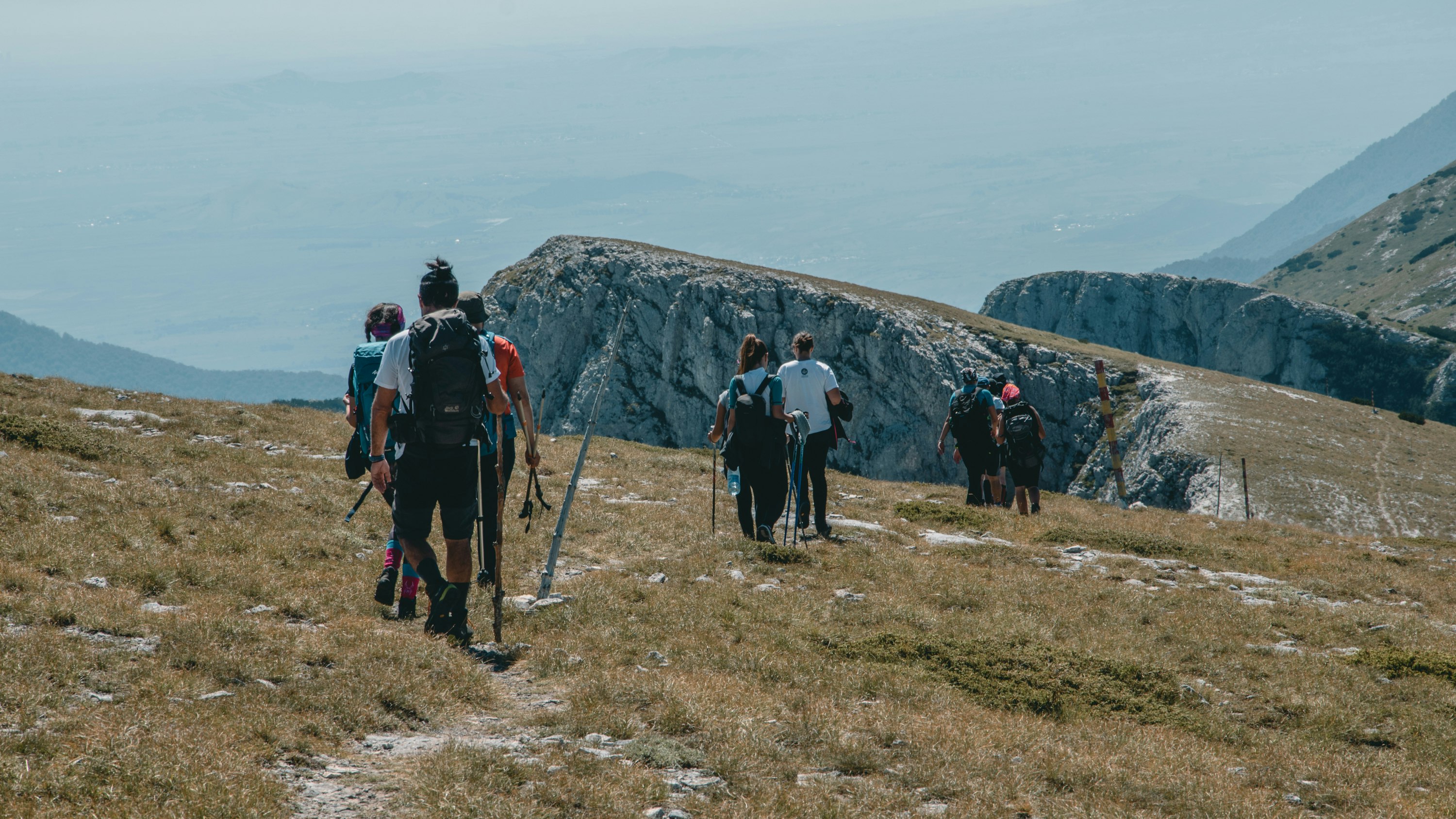 people hiking on mountain during daytime